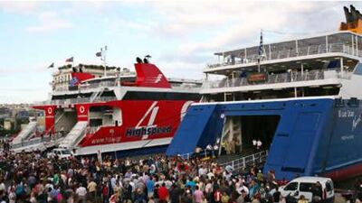 Tourists wait at the port of Piraeus, Greece, as members of the communist's labour union (PAME) prevent them from embarking on ferries heading to Aegean islands on Wednesday, June 23, 2010.