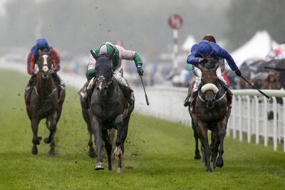 Jim Crowley rides Here Comes When, centre in pink, to victory in the Sussex Stakes, beating Ribchester, right. at Goodwood. Alan Crowhurst / Getty Images