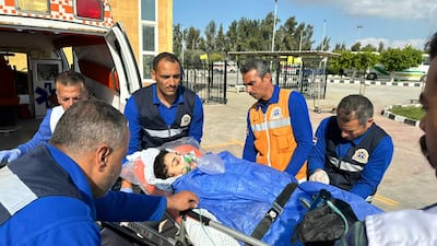 Egyptian paramedics receive an injured Palestinian evacuated from Gaza through the Rafah crossing. AFP