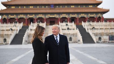 US President Donald Trump holds hands with first lady Melania Trump in the Forbidden City in Beijing. Jim Watson / AFP Photo
