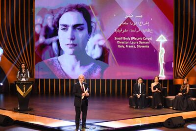 Director of Italian culture in Egypt, David Scalmany receives The Silver Pyramid on behalf of Laura Samani during the closing ceremony of the 43rd Cairo International Film Festival. AFP