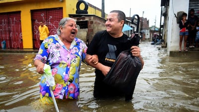 People attempt to make their way through a flooded avenue after a torrential rain in Recife, Brazil, on Thursday during the 2014 World Cup. Patrik Stollarz / AFP / June 26, 2014