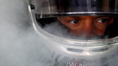 Sebastian Vettel cools off inside his car in the pit lane at Yas Marina Circuit. Vladimir Rys/Getty Images