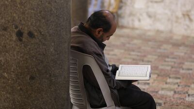 Palestinian reads verses from the Koran during the Islamic holy month of Ramadan, in the West Bank city of Nablus. EPA