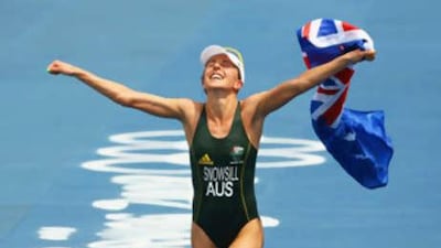 Emma Snowsill of Australia celebrates after taking the gold medal in the women's triathlon event.