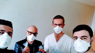 Staff of the Italian start-up Isinnova showing valves produced with a 3D printer for hospitals in Brescia. Reuters