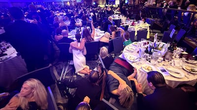 Guests take cover after U. S. President Donald Trump and first lady Melania Trump were rushed out of the White House Correspondents' Association dinner by Secret Service agents after a loud, unidentified noise, in Washington, D. C. , U. S. April 25, 2026. Picture taken using a mobile phone. REUTERS / Evan Vucci