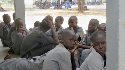 Male students sit in the courtyard of a high school in Fotokol, northern Cameroon, where the pupils and teachers are fearful of attacks by Islamist group Boko Haram. Stray bullets regularly whizz through the courtyard of the Fotokol high school - a terrifying reminder of the Boko Haram gunmen carrying out deadly raids just across the border with Nigeria. Reinnier Kaze/AFP Photo
