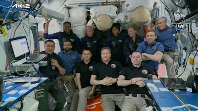 Top row from left, Ali Al Qarni, John Shoffner, Rayyanah Barnawi and Peggy Whitson, pose for a picture with current residents of the International Space Station. The space station has rolled out the welcome mat for the two Saudi visitors, including the kingdom's first female astronaut. AP
