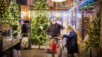 Dutch shoppers browse Christmas trees. Announcing an extension of restrictions in the Netherlands, Mr Rutte acknowledged it was “not the glad tidings you hope for at Christmas time”. AFP