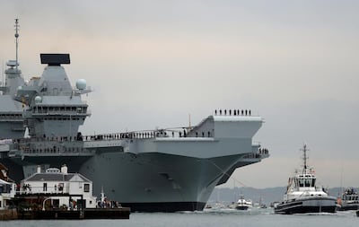 Royal Navy aircraft carrier, HMS Queen Elizabeth, is towed by tugs as it arrives at Portsmouth Naval base, Britain August 16, 2017. Reuters