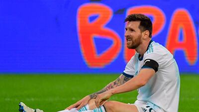 Argentina's Lionel Messi sits on the ground after being fouled. AFP