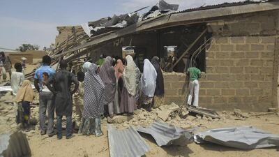 People gather at the site of suicide bomb attack at Redeem Christian church in Potiskum, Nigeria. Adamu Adamu / AP Photo