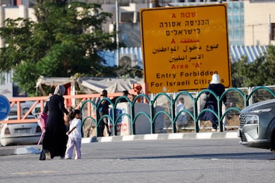 Palestinian students cross an Israeli checkpoint as they return to school for the new academic year, near Hebron. Reuters