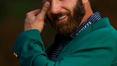 Dustin Johnson celebrates with his green jacket. Reuters