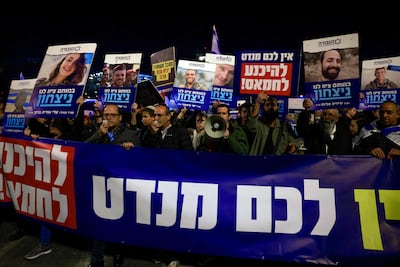 Right-wing Israelis hold pictures of fallen soldiers during a January 13 rally in Jerusalem, where they called for any deal with Hamas to be rejected. AFP