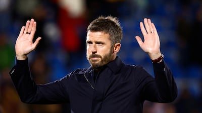 Dejected Manchester United manager Michael Carrick acknowledges the away fans after the game. Reuters.