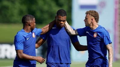 Netherlands' Tyrell Malacia, Denzel Dumfries and Noah Lang. Reuters