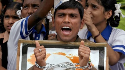 August 18, 2011: A supporter of Anna Hazare wearing a handcuff shouts anti-government slogans as he holds his portrait during a protest against corruption in the southern Indian city of Hyderabad. Despite the Delhi Police's attempts to free him hours afte???