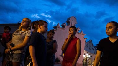El Paso residents stand outside after a vigil ceremony at Saint Pius X Church. AFP