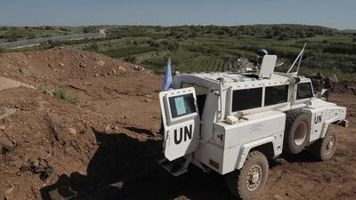 A peacekeeper of the United Nations Disengagement Observer Force (UNDOF) holds a position near the border with Syria in the Israeli-occupied sector of the Golan Heights on April 17, 2016. The Arab League has condemned Israeli prime minister Benjamin Netanyahu's pledge that the Israeli-annexed Golan Heights would "forever" remain in his country's hands. Jalaa Marey/ AFP