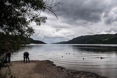 Visitors beside Loch Ness. AFP