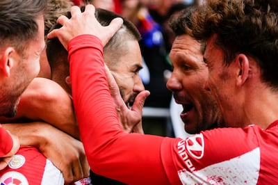 Atletico Madrid's Yannick Carrasco celebrates with coach Diego Simeone after scoring the winner. AP