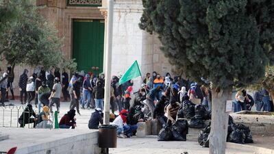 Palestinians gather at the compound after violence broke out on Friday. AFP