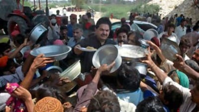 Flood survivors jostle for food distribution in Sukkar, Pakistan.