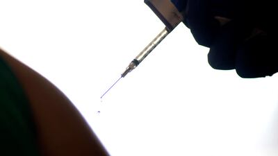 A health care worker is injected with an official Covid-19 vaccine in the US in 2020. In Egypt, a rise in the uptake of unauthorised flu shots is causing concern among medical professionals. AP
