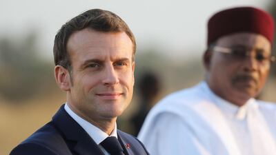 France's President Emmanuel Macron (L) and Niger's President Mahamadou Issoufou (R) take part in a military ceremony at the Martyr Quarter on December 22, 2019, in Niamey, to pay homage to 71 Nigerien soldiers massacred in an attack on December 10 at the Inates military camp in the Sahel country's western Tillaberi region. AFP / POOL / Ludovic MARIN