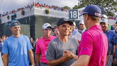 Justin Thomas, right, is greeted by Rickie Fowler, centre, and Jordan Spieth, left, after winning the US PGA Championship. Erik S Lesser / EPA