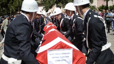 The coffins of two Turkish police officers during their funeral on July 23, in Sanliurfa, after they were found shot dead at their home in the Turkish town of Ceylanpinar on the border with Syria. Bulent Kilic/AFP Photo
