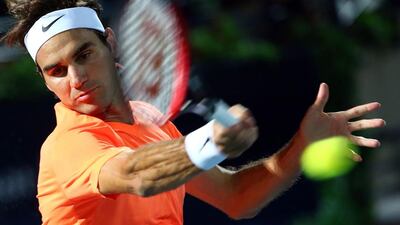 Federer returns the ball to Djokovic of Serbia during the Dubai Duty Free Tennis Championships final. Marwan Naamani / AFP