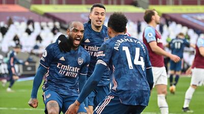 Arsenal's Alexandre Lacazette celebrates with teammates after scoring the third goal against West Ham on Sunday. EPA