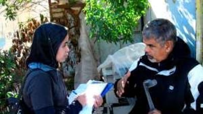 Wafaa Afkir, a student researcher, interviews Nourdine Daif, a telephone kiosk owner, to document his experiences for the Ben M'sik Community Museum, part of the Université Hassan II Mohammedia's local campus.