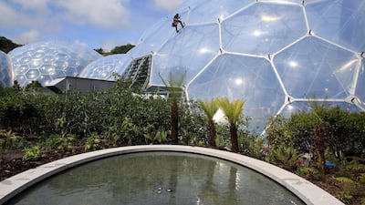 ST AUSTELL, ENGLAND - MAY 31: A rope access technician climbs in front of Eden's latest attraction 'The Sense of Memory Garden' at the Eden Project on May 31, 2012 near St Austell, Cornwall, England. The garden - featuring water pools lined with Bodmin Moor granite and filled with some of Cornwall’s most popular plants - was first seen at the 2011 Royal Horticultural Society Chelsea Flower Show, but has been given a permanent home in front of the Eden Project's Mediterranean Biome. (Photo by Matt Cardy/Getty Images)