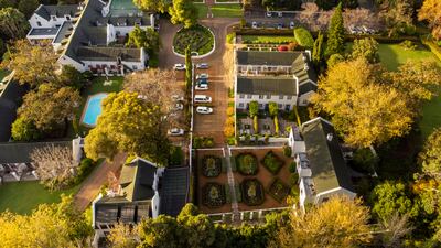The property is surrounded by gardens and has Table Mountain as a backdrop
