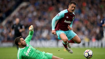 West Bromwich Albion goalkeeper Ben Foster, left, slides in on West Ham United's Javier Hernandez. Nick Potts / AP Photo