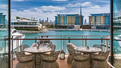 The Yacht Club has an outdoor terrace and a comfortable indoor space. Bulgari Resort Dubai