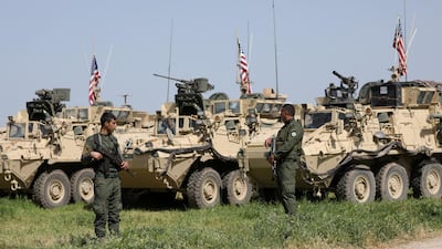 Kurdish fighters from the People's Protection Units (YPG) stand near US military vehicles in the town of Darbasiya next to the Turkish border, Syria April 29, 2017. Reuters