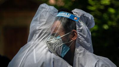 A relative comforts the wailing son of a person who died of COVID-19, at a crematorium in Srinagar, Indian controlled Kashmir. India's death toll is the third-highest reported in the world after the U.S. and Brazil. AP Photo