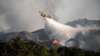 The UK government has stopped short of telling people not to travel to wildfire-hit parts of Greece such as Rhodes. AFP