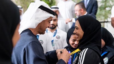 President Sheikh Mohamed receives members of the UAE jiu-jitsu team from the Asian Games in Japan. Ryan Carter / UAE Presidential Court