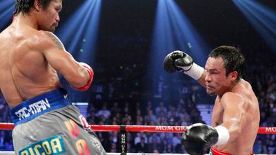 Manny Pacquiao, left, watches as Juan Manuel Marquez, right, is knocked down in the fifth round. Steve Marcus / Reuters