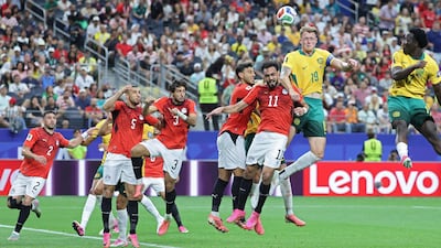 Players jump for the ball which leads to Egypt Mohamed Hany scoring an own-goal. AFP