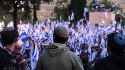 Pro-government protesters wave Israeli flags as they gather near Israel's parliament in Jerusalem. AFP