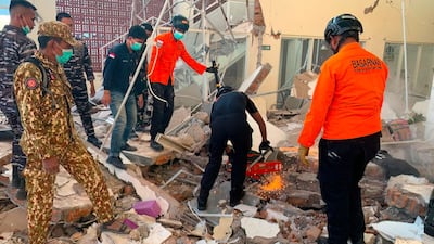 Rescuers remove rubble in Maumere, eastern Indonesia, after a 7.7-magnitude earthquake struck the country. AFP