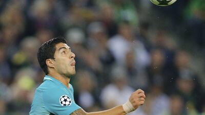 Barcelona’s Luis Suarez eyes the ball during the Champions League match against Borussia Monchengladbach. Michael Probst / AP Photo