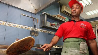 The paratha, an Indian flatbread, has also evolved into a series of colourful no-frills dishes, with perhaps the most ubiquitous being the Chips Oman sandwich. Pawan Singh / The National